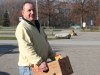 Jim carrying box to delivery vehicle